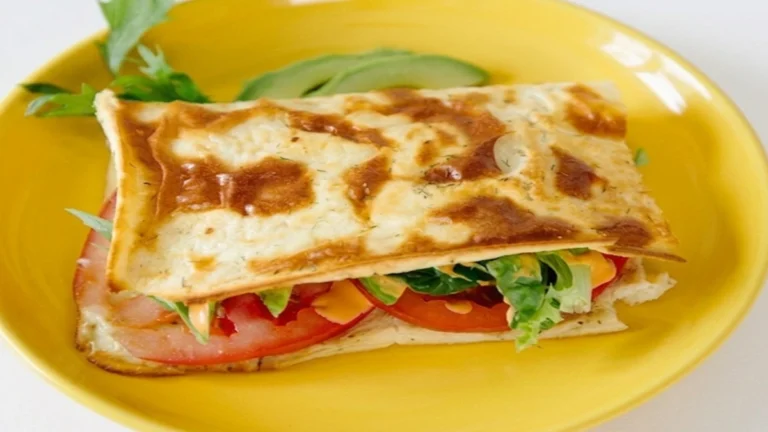 Cottage Cheese Flatbread Recipe served with fresh lettuce, tomato, creamy sauce, and melted cheese on a yellow plate.