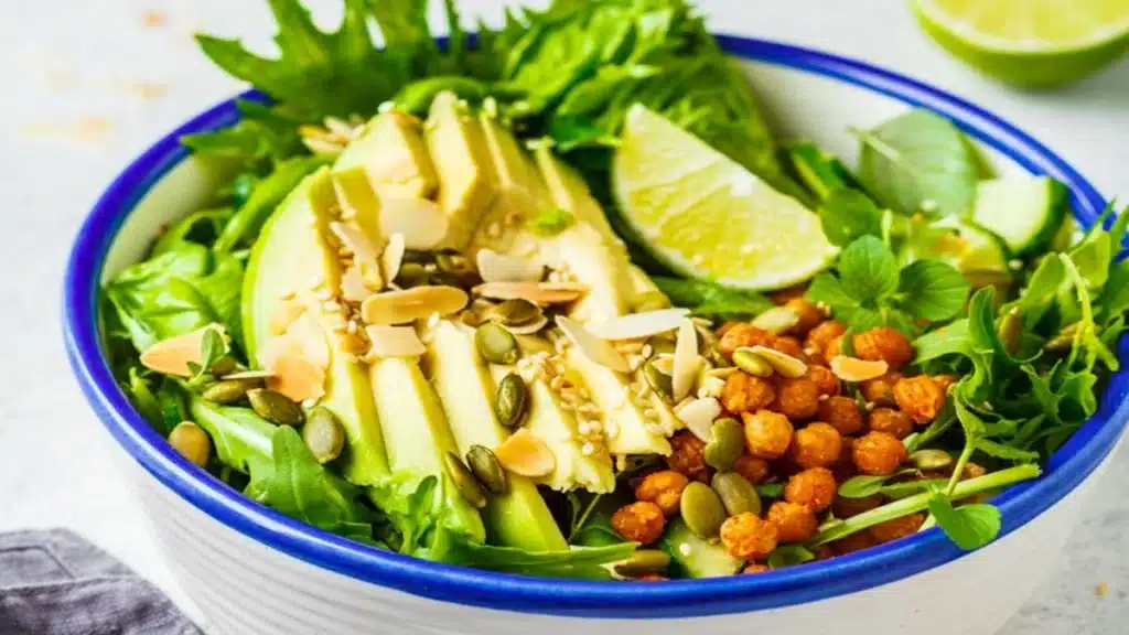 Green Goddess Chickpea Sala with avocado roasted chickpeas seeds greens and fresh lemon healthy vegan bowl.
