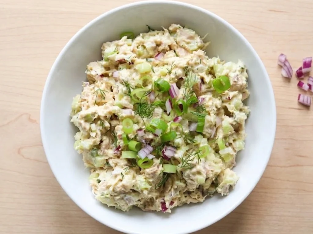 Healthy Cottage Cheese Tuna Salad in a bowl with tuna, cottage cheese, celery, red onion, and fresh herbs a high protein low carb meal.