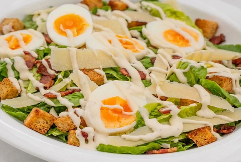Keto Chicken Caesar Salad Bowls with soft boiled eggs, parmesan cheese, crispy croutons and creamy Caesar dressing.