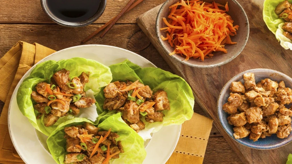 👉 Keto Chicken Lettuce Wraps made with seasoned chicken, fresh lettuce leaves, and shredded carrots, served as a low carb healthy meal.