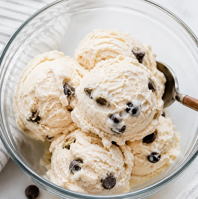 Creamy Cottage Cheese Protein Ice Cream served in a glass bowl with chocolate chips, featuring rich texture and a high-protein frozen dessert.