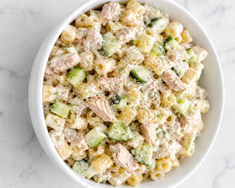 Creamy Crunchy Pasta Tuna Salad served in a white bowl with cucumber chunks and tender tuna pieces.