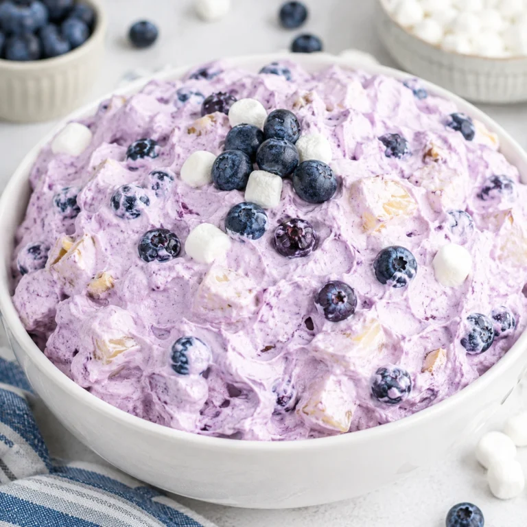 The Best Blueberry Fluff Salad for Summer Parties served in a white bowl with fresh blueberries, mini marshmallows, and creamy fluffy texture.