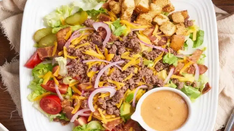 25-Minute Cheeseburger Bowl with ground beef, cheddar cheese, bacon, lettuce, tomatoes, onions, pickles, and creamy burger sauce in a healthy low-carb bowl.