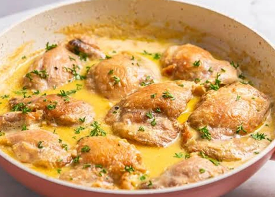 Creamy Garlic Butter Chicken Thighs cooked in a rich garlic butter sauce in a skillet, featuring juicy golden-brown chicken and fresh herbs for an easy family dinner.